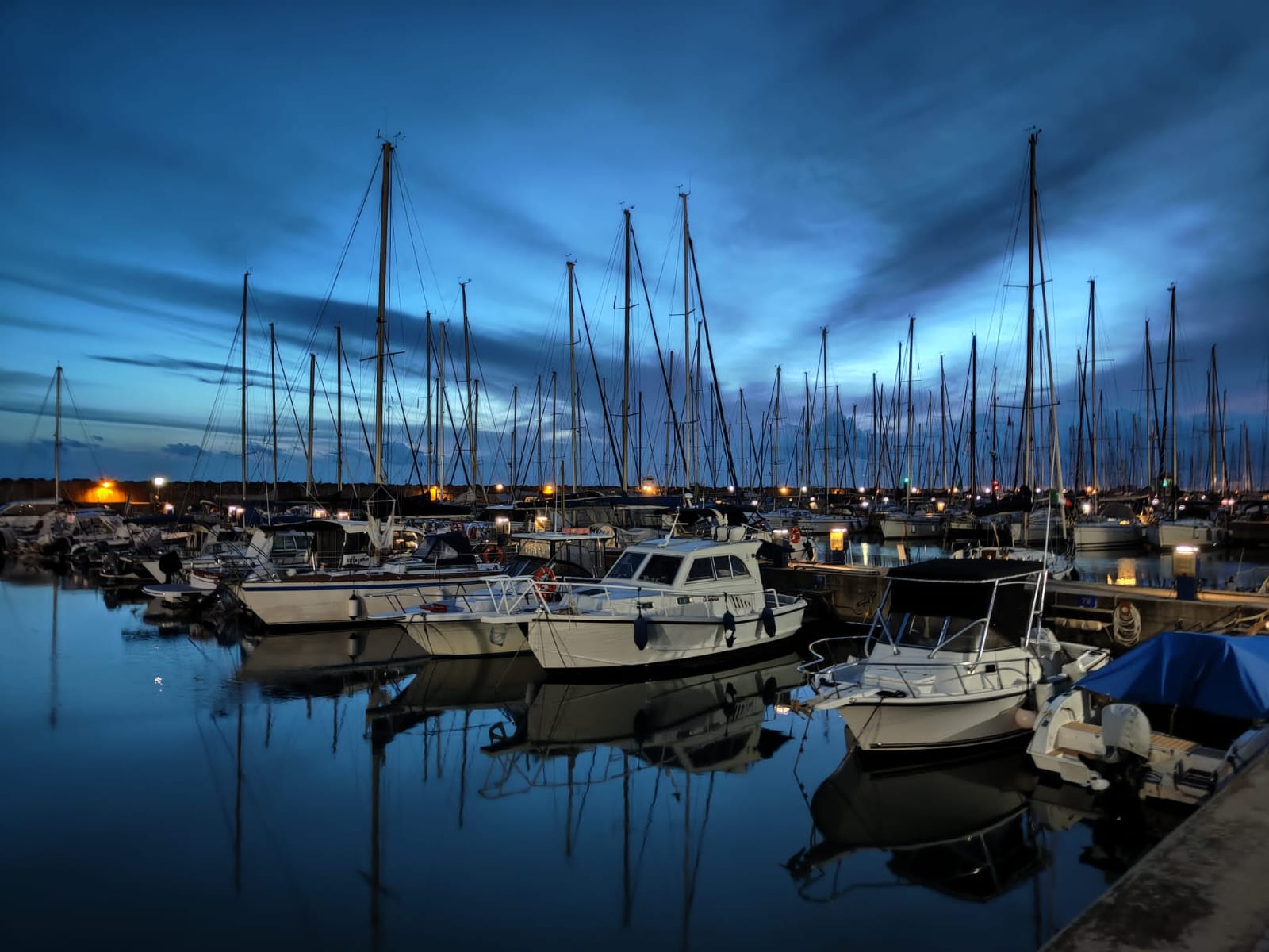 View of the Port of Rome in Ostia, with boats moored along the Mediterranean coastline.